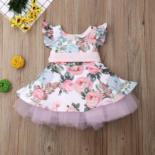 Our Spring Floral Dress Makes us think of an adorable English Tea Party. This dress would be adorable for Easter or for a little girls birthday party. We love the tulle skirt that makes this extra fluffy and feminine.